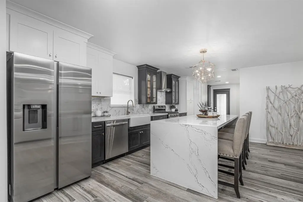 Two-tone cabinets with waterfall island and quartz counters